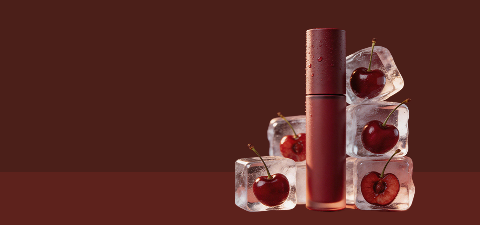 A dark red liquid lipstick tube stands upright next to several clear ice cubes, each containing a red cherry, against a solid dark reddish-brown background.
